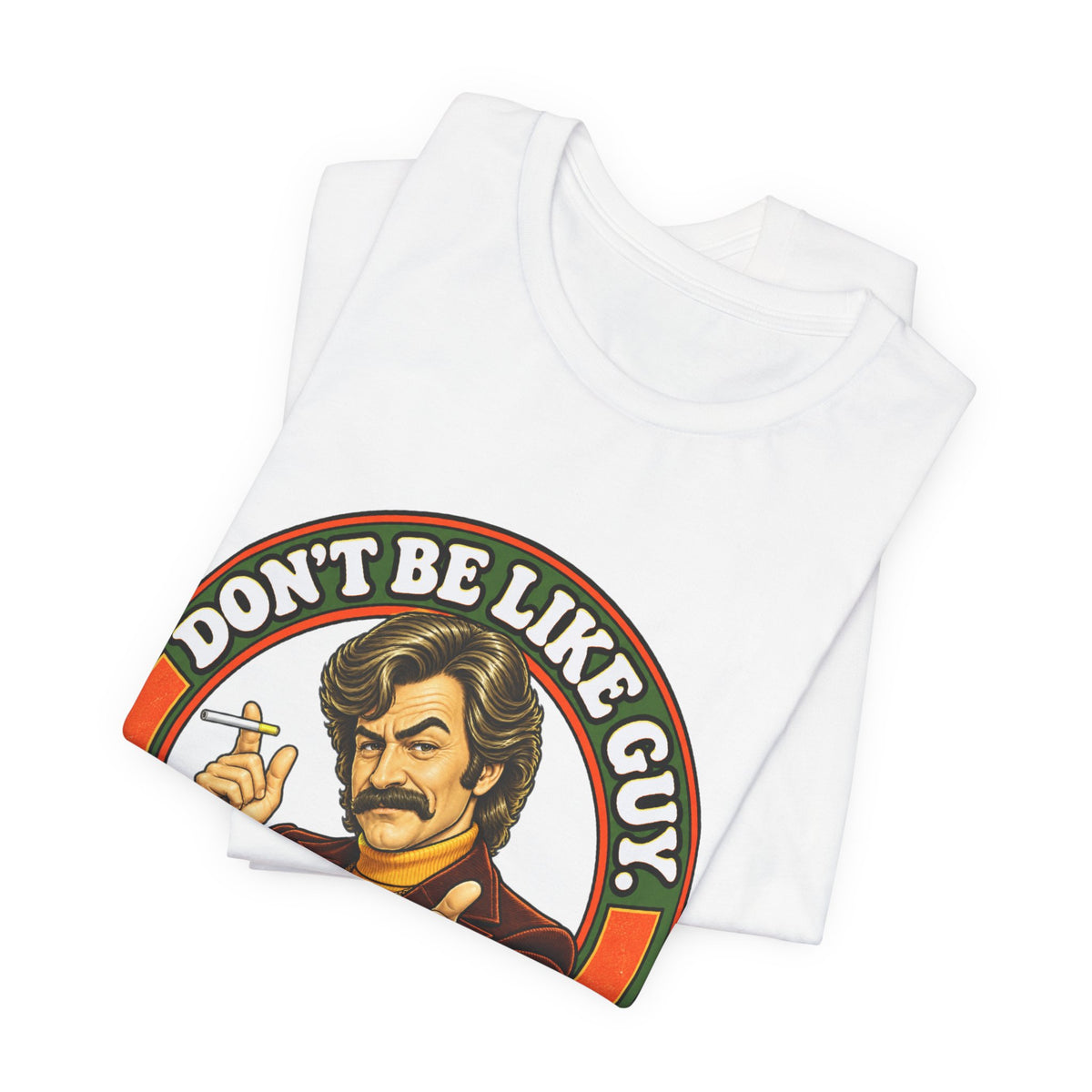 Folded white t-shirt showing 'Don't Be Like Guy' retro illustration
