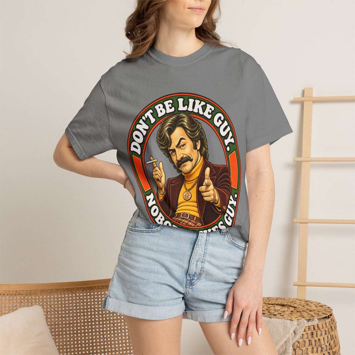 Model wearing gray 'Don't Be Like Guy' retro graphic shirt