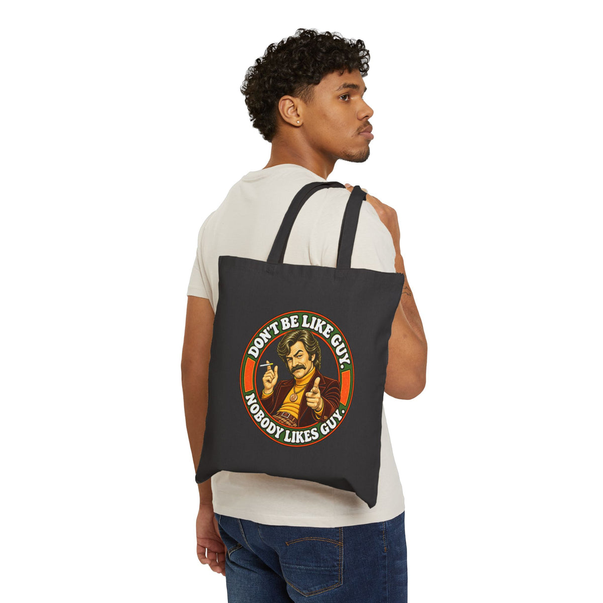 Person carrying black canvas tote with retro humor graphic
