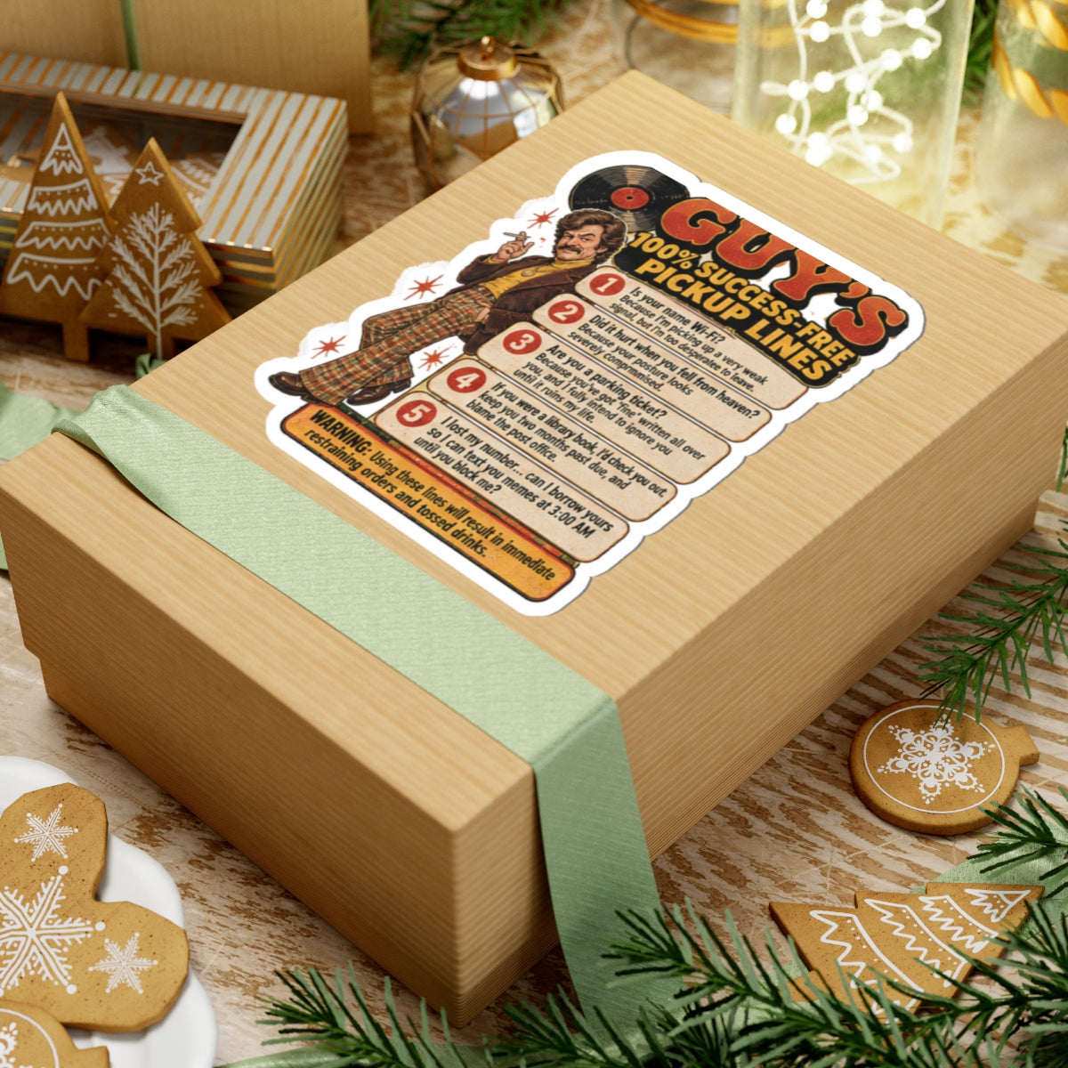 Stickers featuring Guy's 100% Success-Free Pickup Lines on a gift box near cookies and Christmas decor