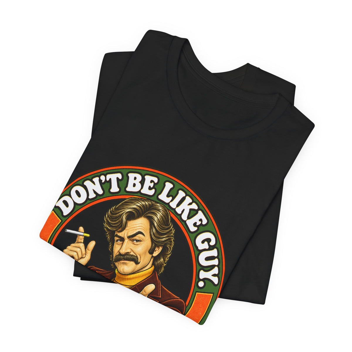 Folded black t-shirt featuring 'Don't Be Like Guy' vintage print