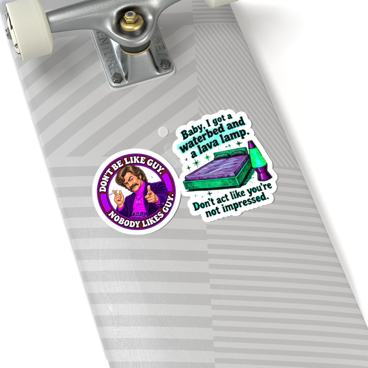 The stickers stuck to a skateboard, showcasing bold pop culture humor.