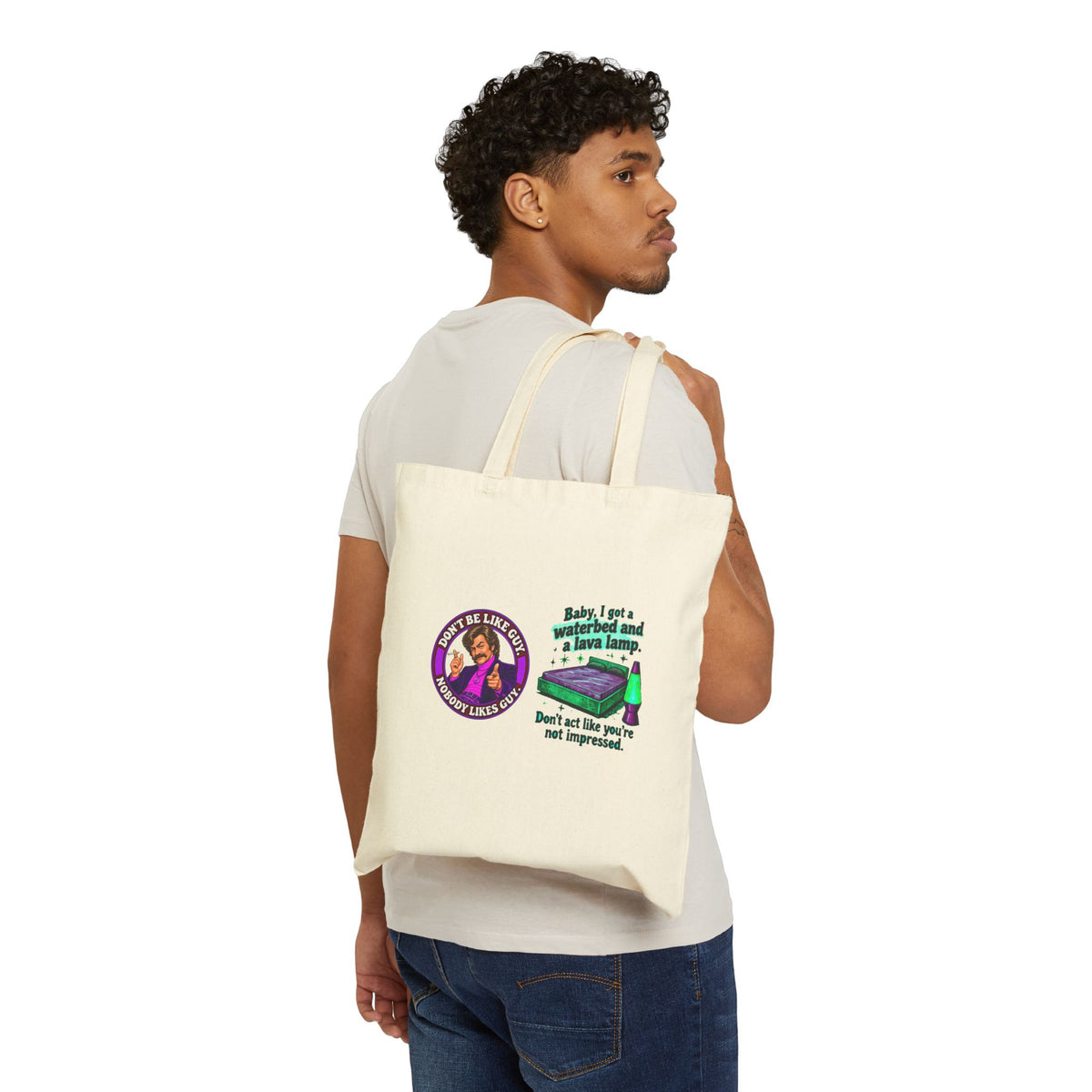 Person carrying natural canvas tote bag with retro cat and lamp graphic