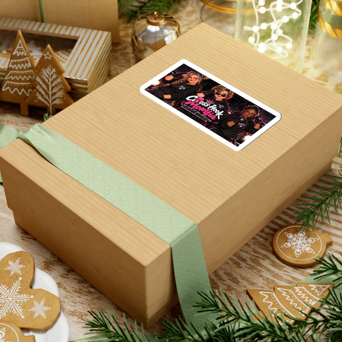 Sticker affixed to a wrapped gift box, surrounded by festive decorations.