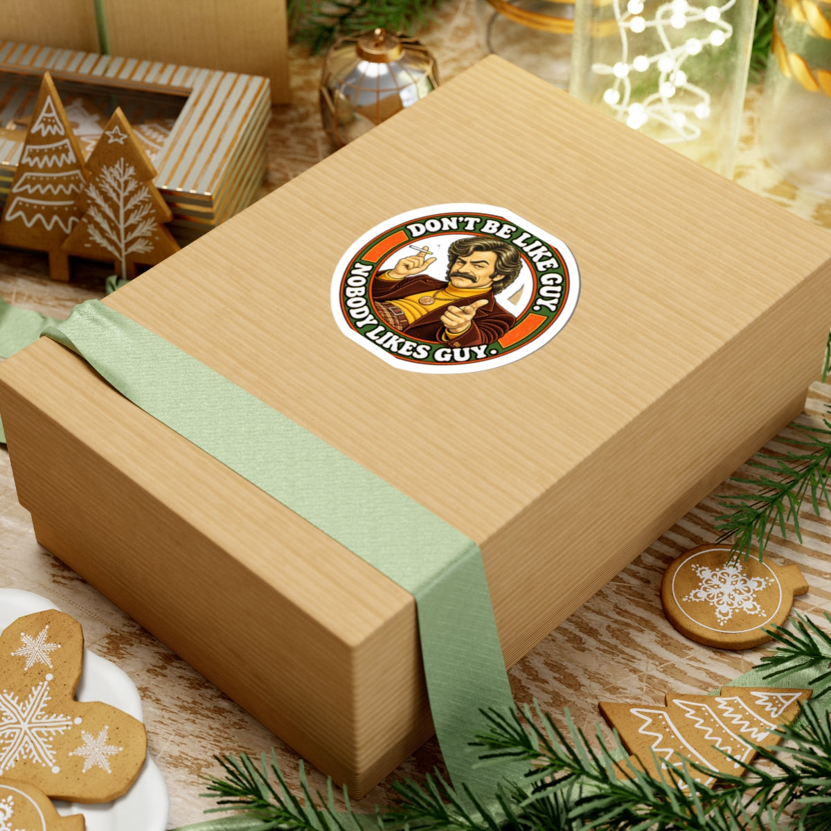 Sticker on gift box with green ribbon and holiday cookies nearby
