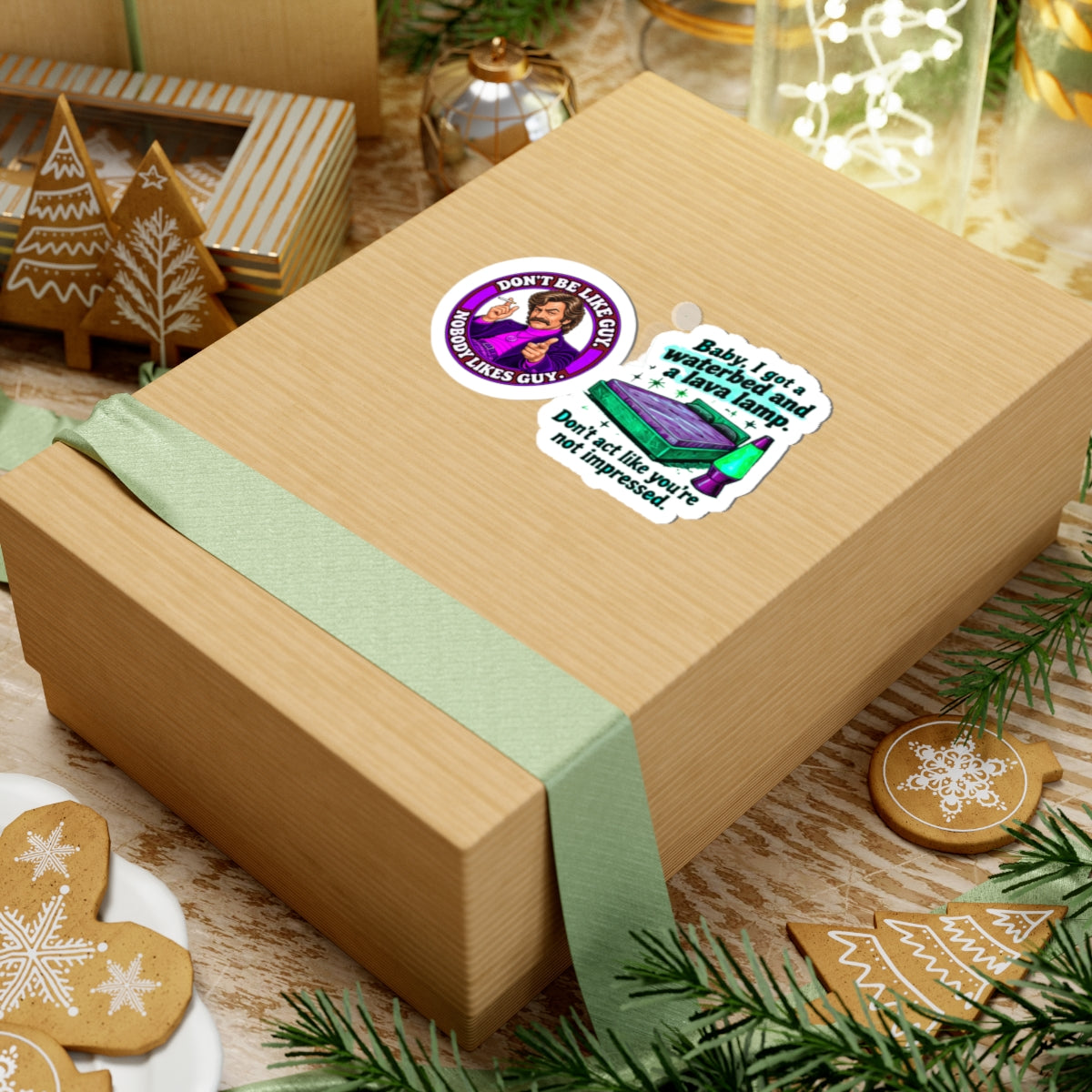 Gift box topped with the two stickers, surrounded by festive holiday decor.