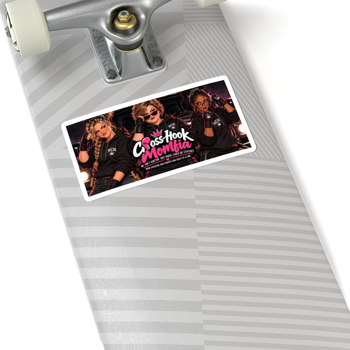 Sticker applied to a skateboard deck, standing out with its neon 'Momfia' graphics.