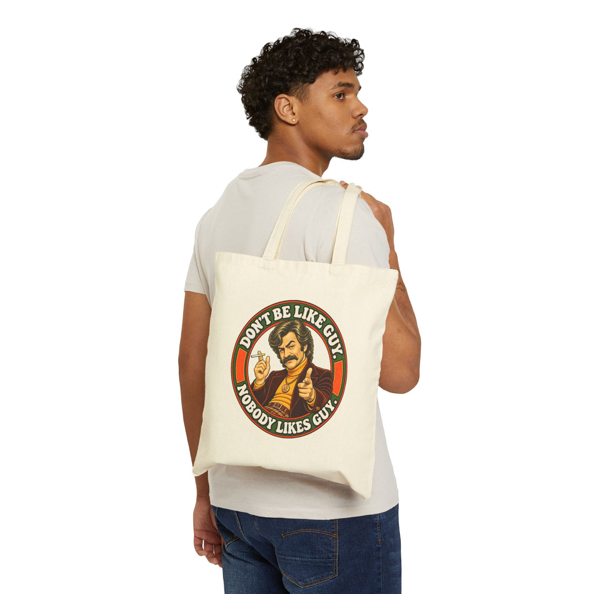Model carrying natural cotton tote bag with 'Don't Be Like Guy' graphic