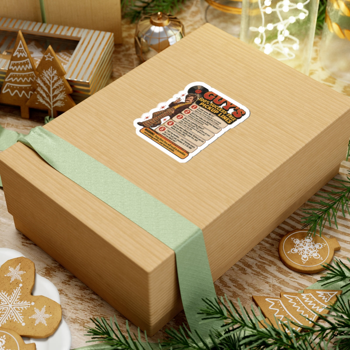 Sticker on a gift box surrounded by holiday decorations and cookies