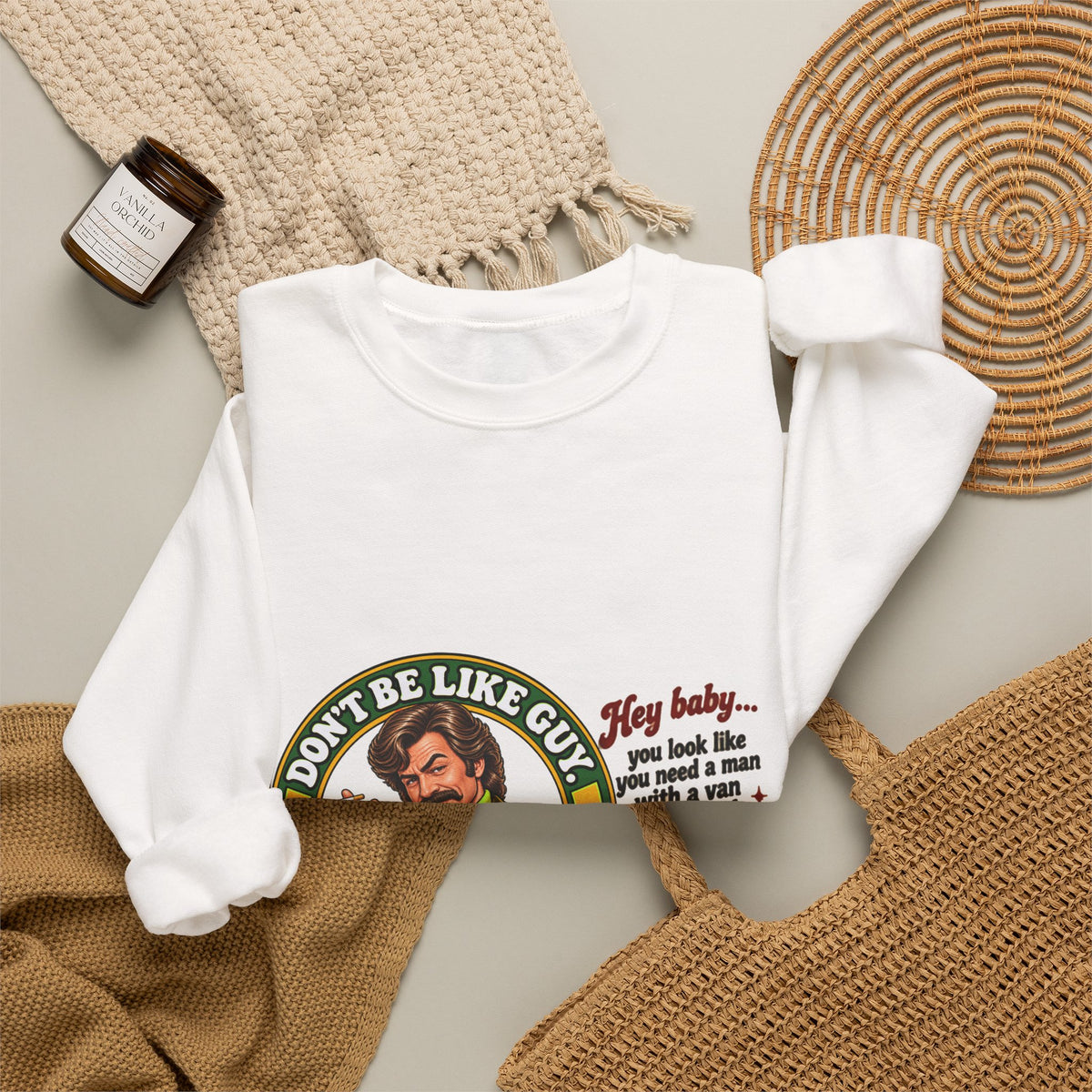 White crewneck sweatshirt styled on a flat lay with home decor items